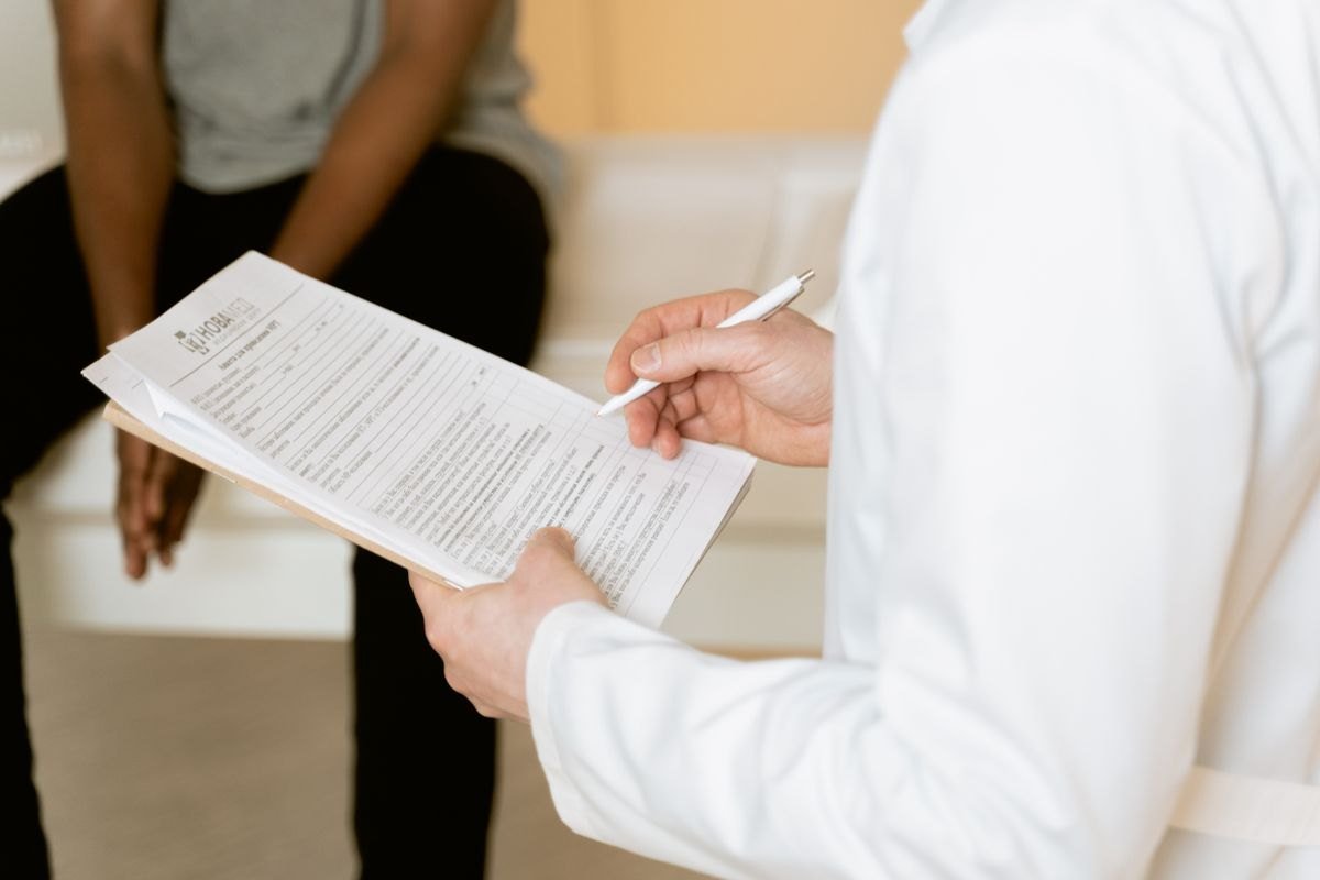 A healthcare professional explaining a medical form during a consultation